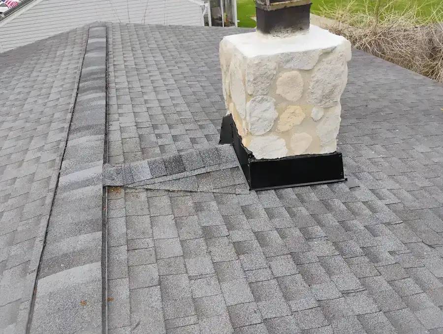 Fresh chimney flashing repair with new EPDM counter flashing and sealant applied, Metro Detroit