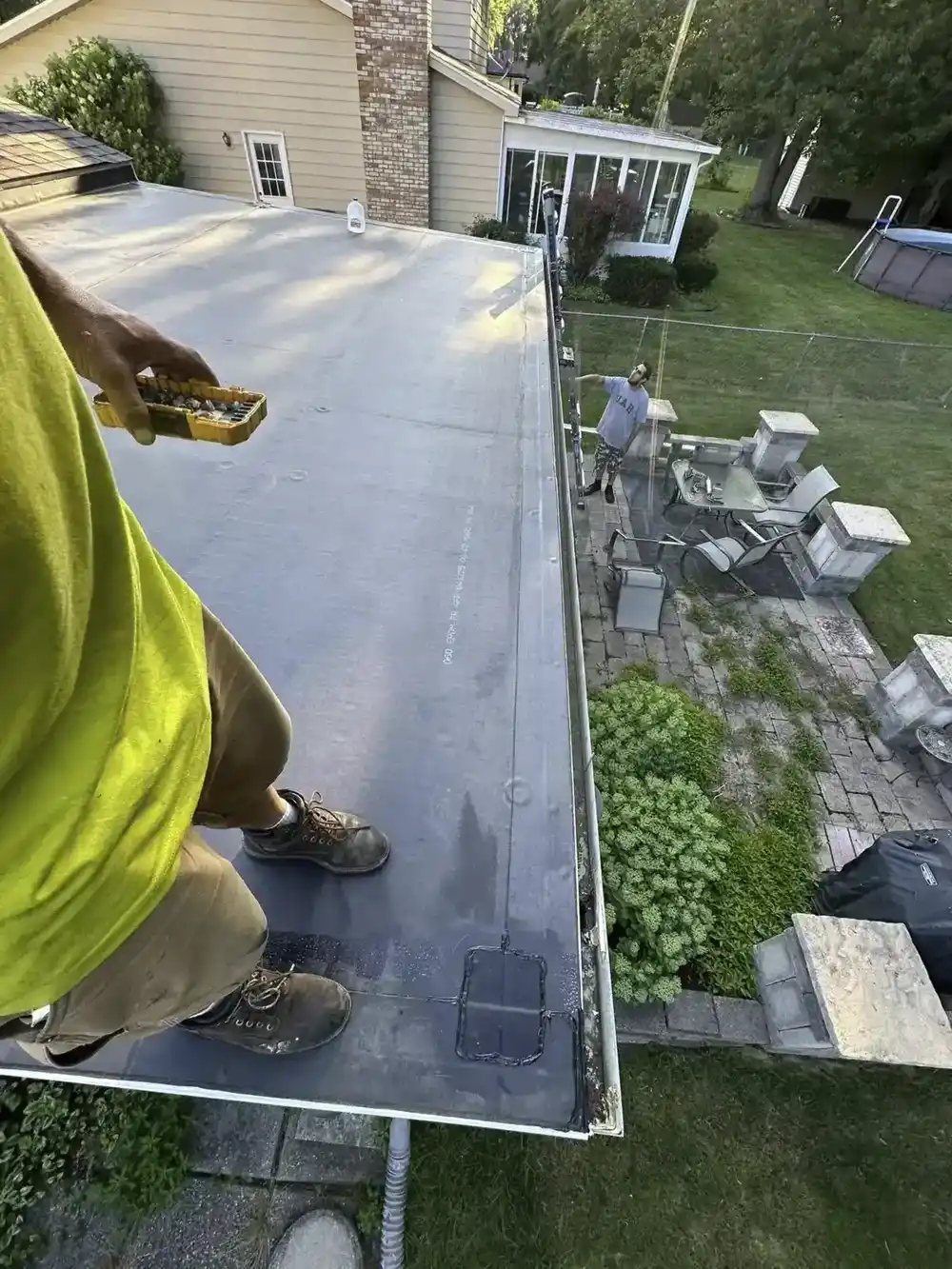Crew installing EPDM rubber membrane on a flat roof