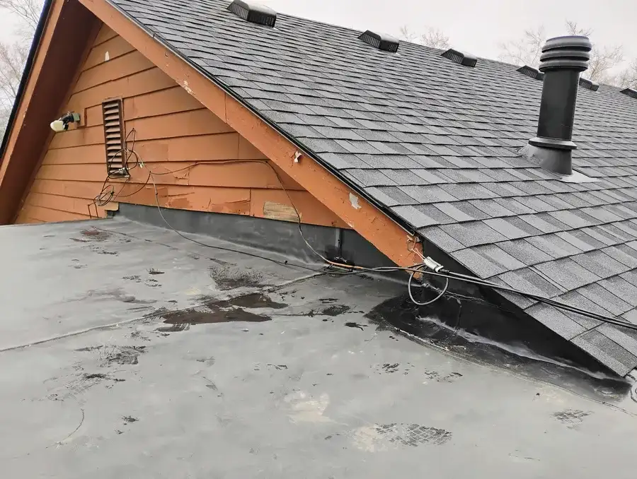 Parapet wall damage on a flat roof requiring repair in Oakland County